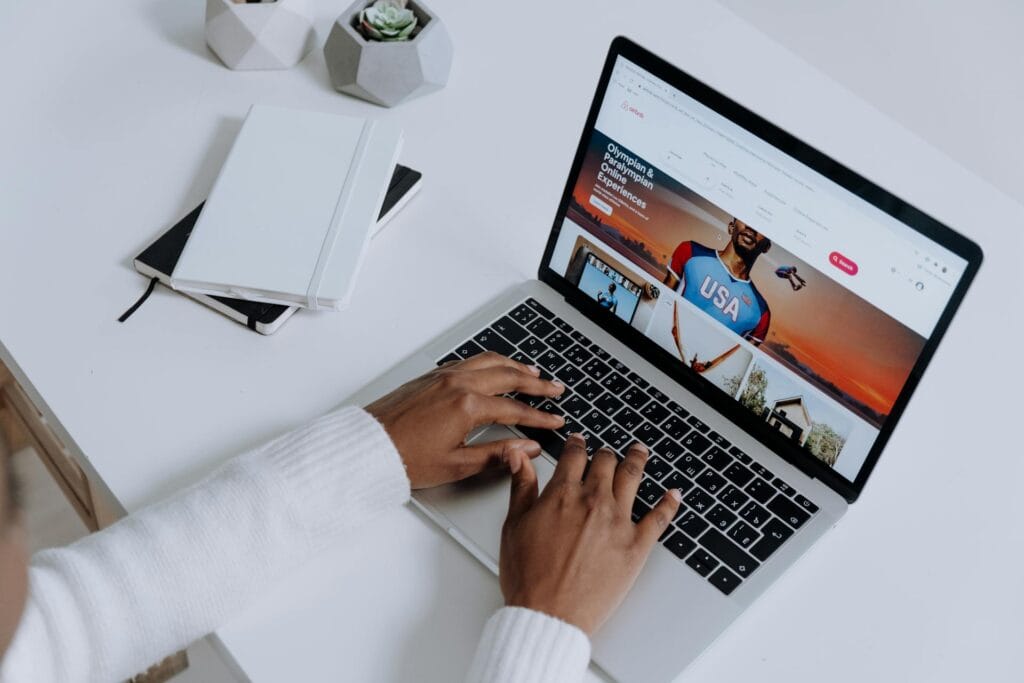 Person working on website development on a laptop for SEO optimization.
